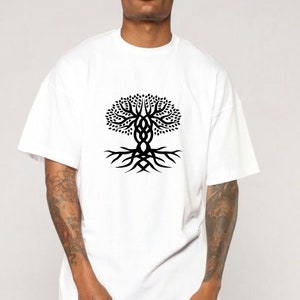May include: White t-shirt with a black tree of life design. The graphic shows a stylized tree with detailed branches and roots, representing growth and connection. The shirt is made of a soft, comfortable material.