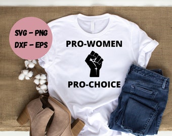 May include: White t-shirt with black text that reads "PRO-WOMEN" and "PRO-CHOICE" with a black fist graphic in between the text.