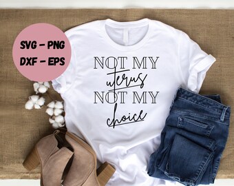 May include: White t-shirt with the text "NOT MY UTERUS NOT MY CHOICE" in black lettering.