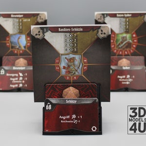 Könnte beinhalten: Ein Set aus drei Miniatur-Spielfiguren-Karten mit einem roten und schwarzen Plastikständer. Die Karten zeigen Illustrationen eines Dinosauriers, einer Kreatur mit Pfeil und Bogen und einer Spinne. Die Karten haben Text in deutscher Sprache, darunter die Wörter "Banditen-Schützin" und "Schütze".