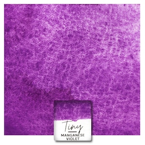 May include: A close-up of a purple watercolor wash with a small square of the same color in the bottom right corner. The square has the text "Tiny Manganese Violet" written on it.