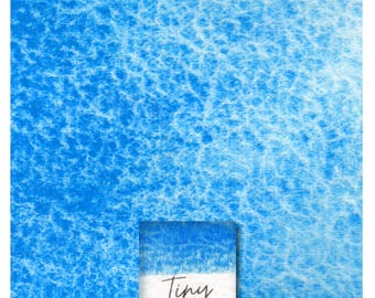 May include: A close-up of a blue watercolour wash with a white label that reads "Tiny Genuine Manganese Blue".