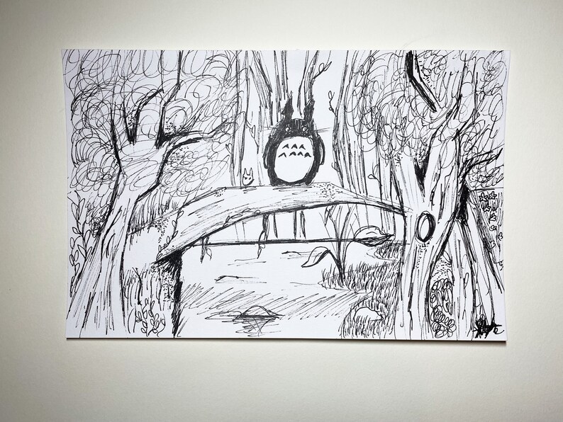 May include: Black and white ink drawing depicting a forest scene with a bridge over water. A large, round, cartoon creature with pointed ears sits on the bridge. Trees and foliage surround the bridge, creating a whimsical landscape.