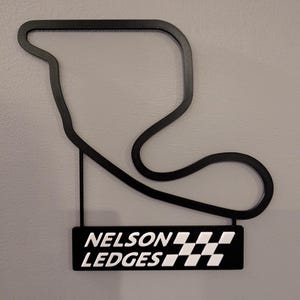 Wandkunst Nelson Ledges-baan met naambord