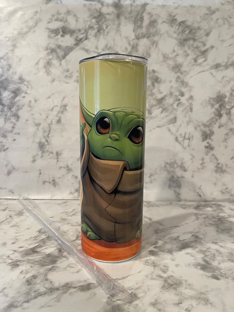 Front view of tumbler showing baby yoda reaching for the sky.