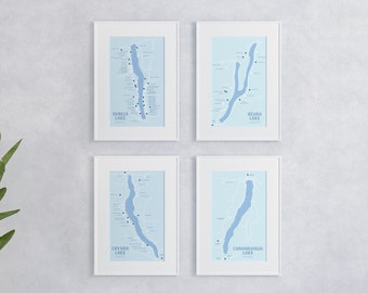 May include: Four framed maps of the Finger Lakes region of New York State. Each map is printed on a light blue background and shows the outline of a lake with the name of the lake printed below: Seneca Lake, Keuka Lake, Cayuga Lake, and Canandaigua Lake.