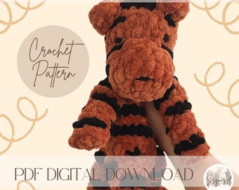 Könnte beinhalten: Ein Häkelmuster für ein Tiger-Amigurumi-Spielzeug. Das Muster ist als digitaler Download erhältlich. Das Bild zeigt ein fertiges Tiger-Spielzeug aus braunem und schwarzem Garn.