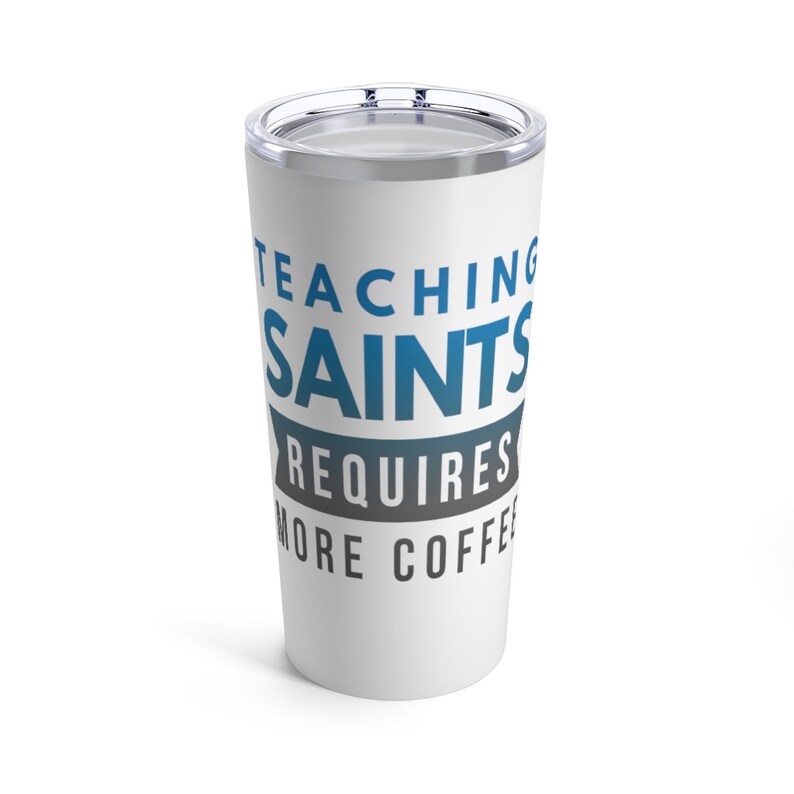 Puede incluir: Taza de viaje de acero inoxidable blanca con un gr&aacute;fico azul y gris que dice "Ense&ntilde;ar a los santos requiere m&aacute;s caf&eacute;".