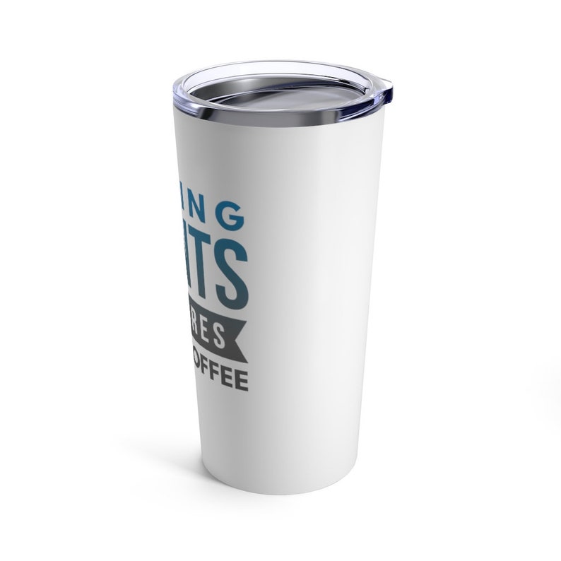 May include: White stainless steel travel mug with a black and blue design that says "Running late requires more coffee".