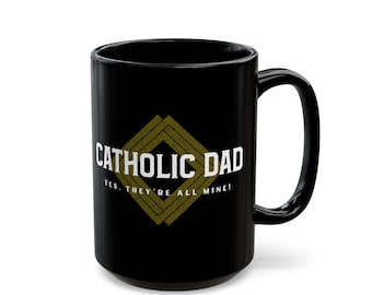 May include: Black ceramic mug with the text "CATHOLIC DAD" in white, inside a diamond-shaped design. Below the text is the phrase "YES, THEY'RE ALL MINE!" in white. The mug has a large handle.