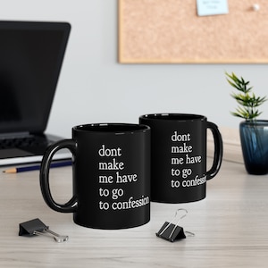 May include: Two black coffee mugs with white text that reads "dont make me have to go to confession".