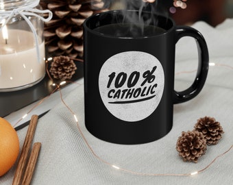 May include: Black coffee mug with a white circle and the text "100% Catholic" in a black font.