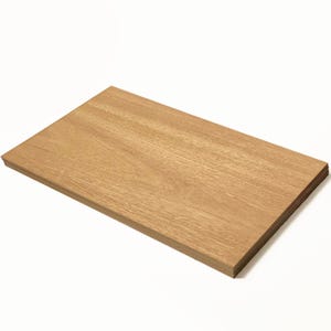 May include: A stack of light brown wood veneer sheets.