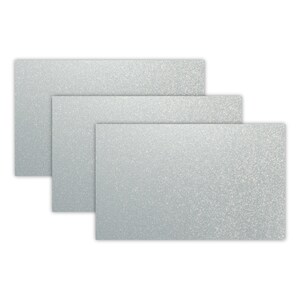 May include: Three silver glitter cardstock sheets in different sizes. The sheets are stacked on top of each other.