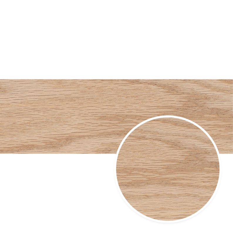 May include: Close-up of the grain pattern of a light brown wood plank. The wood has a natural, warm tone.