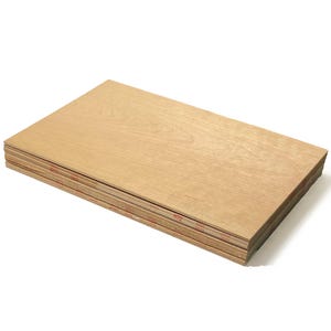 May include: A stack of light brown wood veneer sheets. The sheets are stacked neatly and are ready for use in a variety of woodworking projects.