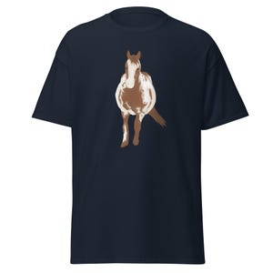 May include: A navy blue t-shirt with a brown and white horse illustration. The horse is standing on its hind legs with its front legs raised.