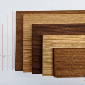 May include: Five wooden boards of different sizes and wood types, arranged in a row from smallest to largest. The boards are 4 inches, 6 inches, 8 inches, 10 inches, and 11 inches long. The wood types are walnut, oak, and cherry.
