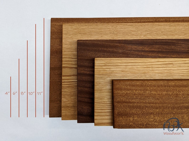 May include: Five wooden boards of different sizes and wood types, arranged in a row from smallest to largest. The boards are 4 inches, 6 inches, 8 inches, 10 inches, and 11 inches long. The wood types are walnut, oak, and cherry.