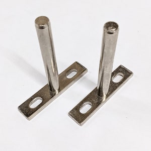 Silver t-shaped floating shelf brackets.