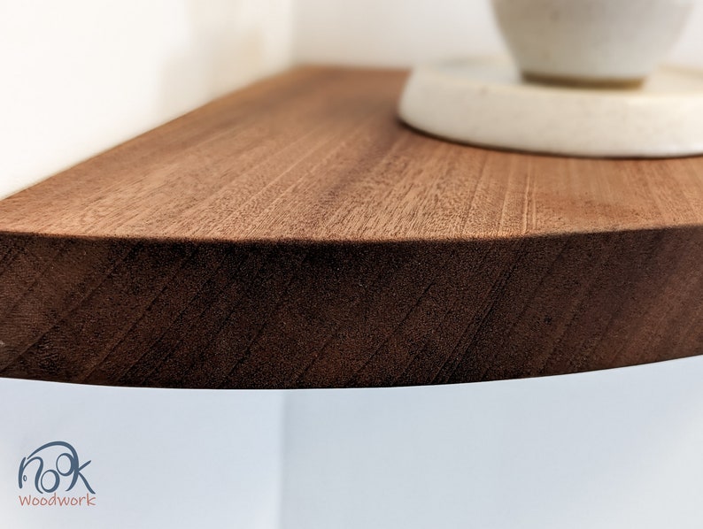 Zoomed in picture of a mahogany corner shelf with soft beveled edges