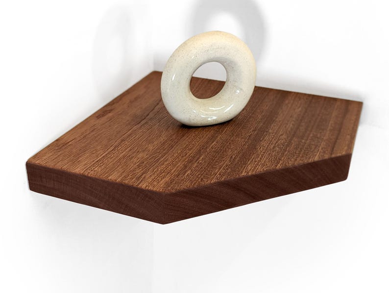 A mahogany corner floating shelves displays a donut sculpture
