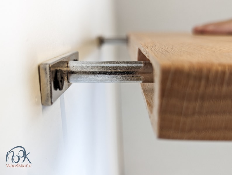 Close up side view of the oak shelf sliding onto the two metal brackets