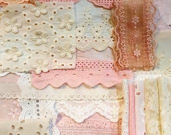May include: Assortment of delicate white and pink lace fabric scraps. The fabric has a variety of patterns and textures, including eyelet, scalloped edges, and floral designs.