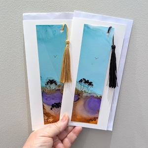 May include: A trio of ceramic vases in different heights and forms. The tallest is light beige, the middle one is a darker brown, and the smallest is speckled white. Each vase has a smooth, matte finish.