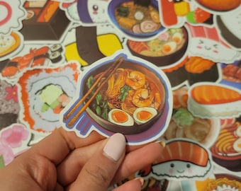 May include: A sticker of a bowl of ramen with chopsticks, shrimp, and green onions. The sticker is on a white background with other stickers of sushi, ramen, and other Japanese food.