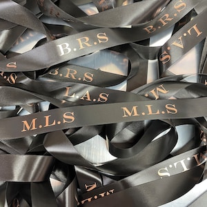 May include: Black satin ribbon with gold lettering. The ribbon reads "B.R.S. L.A.S. M.L.S. B.R.S. S.V.T.I. M.L.S."