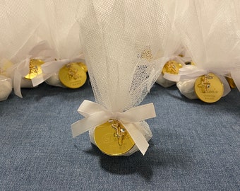 May include: White tulle bags with gold round tags featuring a cross and the text "Giannis's Baptism July 2023".