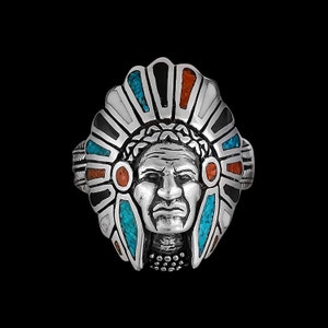 May include: Silver ring with a detailed design of a Native American chief wearing a headdress with turquoise and coral accents.