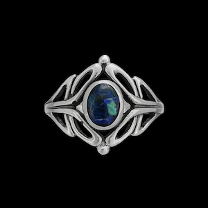 May include: A silver ring with an intricate design featuring a blue and green oval gemstone.