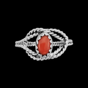 May include: A silver ring with a twisted rope design and a red coral stone in the center.