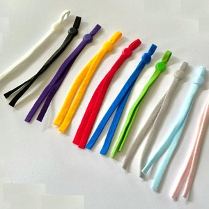 May include: Assortment of 10 colorful elastic cord mask strap extenders with adjustable plastic toggles. The colors include white, black, purple, yellow, red, blue, green, gray, light blue, and pink.