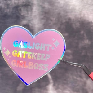 Gaslight Gatekeep Girlboss heart-shaped sticker with holographic lettering - Perfect for laptops, water bottles, etc. - Weatherproof