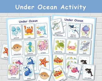 May include: Colorful educational cards featuring various sea creatures, including a jellyfish, crab, dolphin, and octopus. The cards are labeled with the names of the sea animals and the words "Under Ocean" and "Ocean Activity" are displayed at the top.