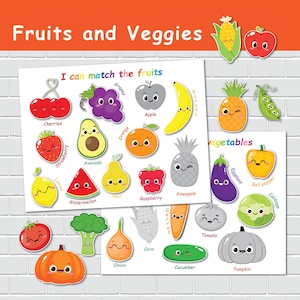 May include: Two educational posters with cartoon illustrations of fruits and vegetables. The top poster says "I can match the fruits" and features cherries, grapes, an apple, and a banana. The bottom poster says "vegetables" and features an eggplant, bell pepper, and cabbage.