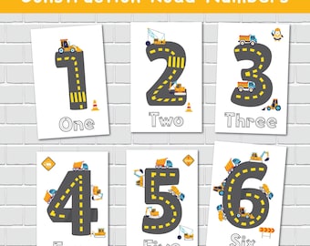 May include: Set of six educational prints featuring numbers 1 through 6 designed as roads with construction vehicles. Each print has a number in a road shape, with the word below. The background is a white brick wall.