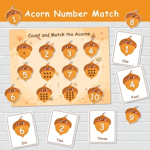 May include: An educational game with an acorn theme. The game includes a board with numbered acorns and matching cards. The text "Acorn Number Match" and "Count and Match the Acorns" are visible. The acorns are brown and the cards are white.