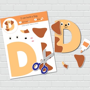 May include: A printable craft activity for kids to build a dog. The printable features a letter D with cut-out pieces to create a dog shape. The instructions say "I can build a Dog", "1 Cut out", "2 Glue", and "Using a marker, draw in a mouth".