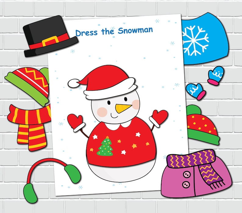 May include: A printable activity sheet featuring a snowman wearing a red sweater with a green Christmas tree and stars. The sheet reads "Dress the Snowman" and includes various clothing items to cut out and stick on the snowman, such as a hat, scarf, mittens, and a coat.