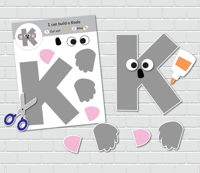 May include: A printable craft activity for kids to build a koala. The craft includes a gray letter K, two gray ears, two gray paws, two pink noses, and two white eyes. The instructions say "I can build a Koala" and include steps to cut out and glue the pieces together.