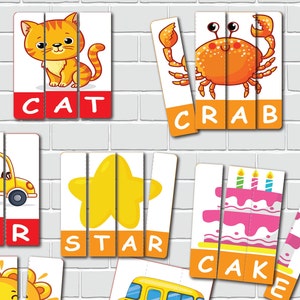 May include: Educational puzzle cards featuring colorful illustrations of a cat, crab, star, and cake. Each puzzle is divided into three pieces, with the corresponding word printed below the image. The background is a white brick wall.