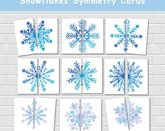 May include: Nine white square cards with watercolor snowflake designs in shades of blue and purple. The cards are arranged in a grid, some split in half, with the text "Snowflakes Symmetry Cards" at the top.