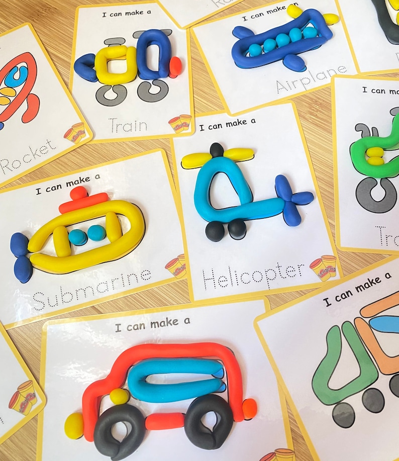 May include: A set of 8 cards with different vehicles made from playdough. Each card has a dotted line outline of the vehicle and the word for the vehicle written below. The vehicles include a rocket, train, airplane, submarine, helicopter, truck, tractor, and a car.