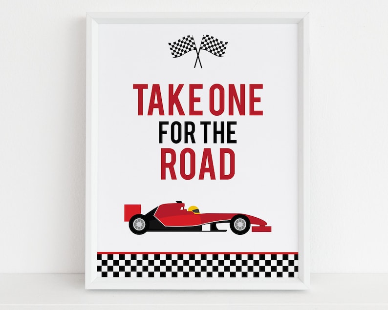May include: A white sign with a red race car and checkered flag border. The text on the sign reads "Take One For The Road".