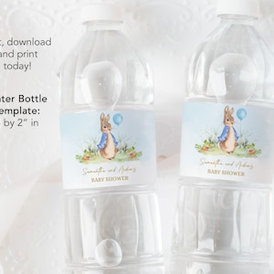 May include: Two clear plastic water bottles with labels featuring a watercolour illustration of a bunny in a blue jacket holding a blue balloon. The labels also include the text "Samantha and Aiden's Baby Shower".