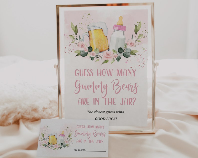 May include: A pink and white printable sign with a floral design and a beer mug and baby bottle. The sign says "Guess how many Gummy Bears are in the jar? The closest guess wins. Good luck!"